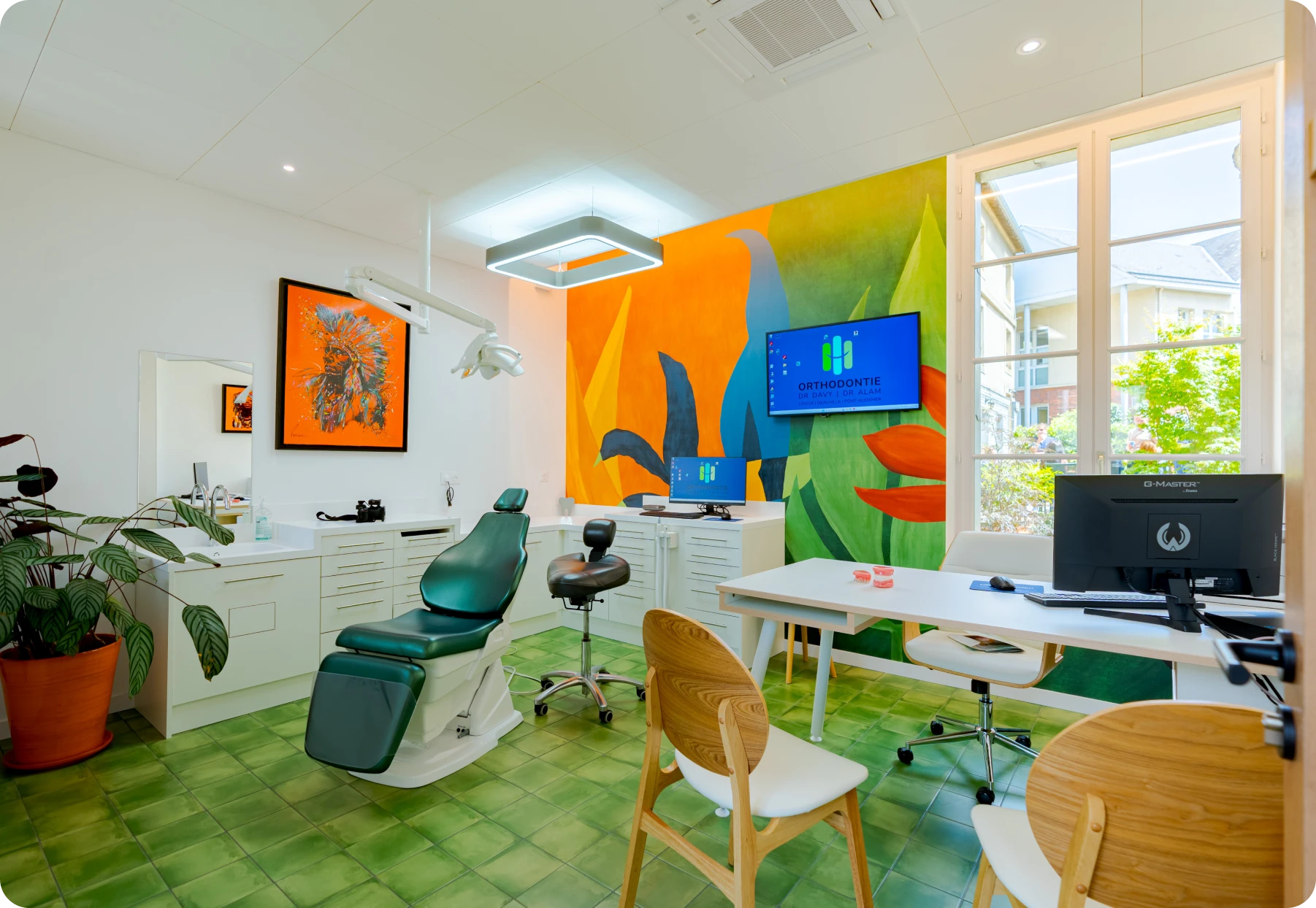 Salle de soins du cabinet d'orthodontie avec fauteuil dentaire et fresque murale tropicale